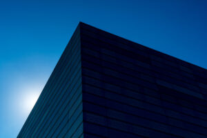 top corner of a large warehouse against a blue sky